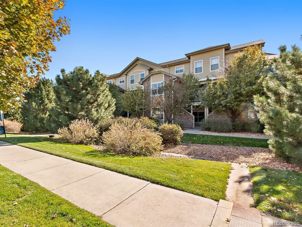5800 Tower Road, Unit 908 Denver, CO 80249 - Photo 18 of 25 a front view of a house with a yard