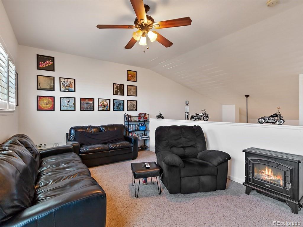 5800 Tower Road, Unit 908 Denver, CO 80249 - Photo 10 of 25 a living room with furniture and a fireplace