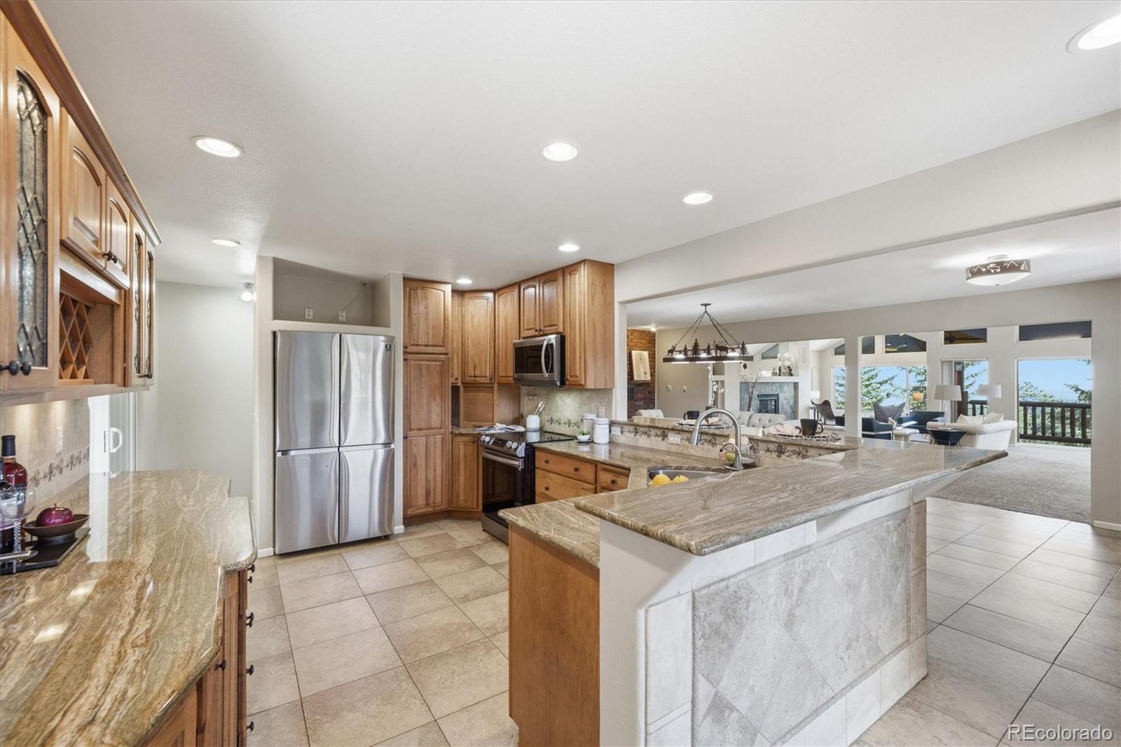 8969 South Hillview Road Morrison, CO 80465 - Photo 16 of 50 a kitchen with a sink and refrigerator