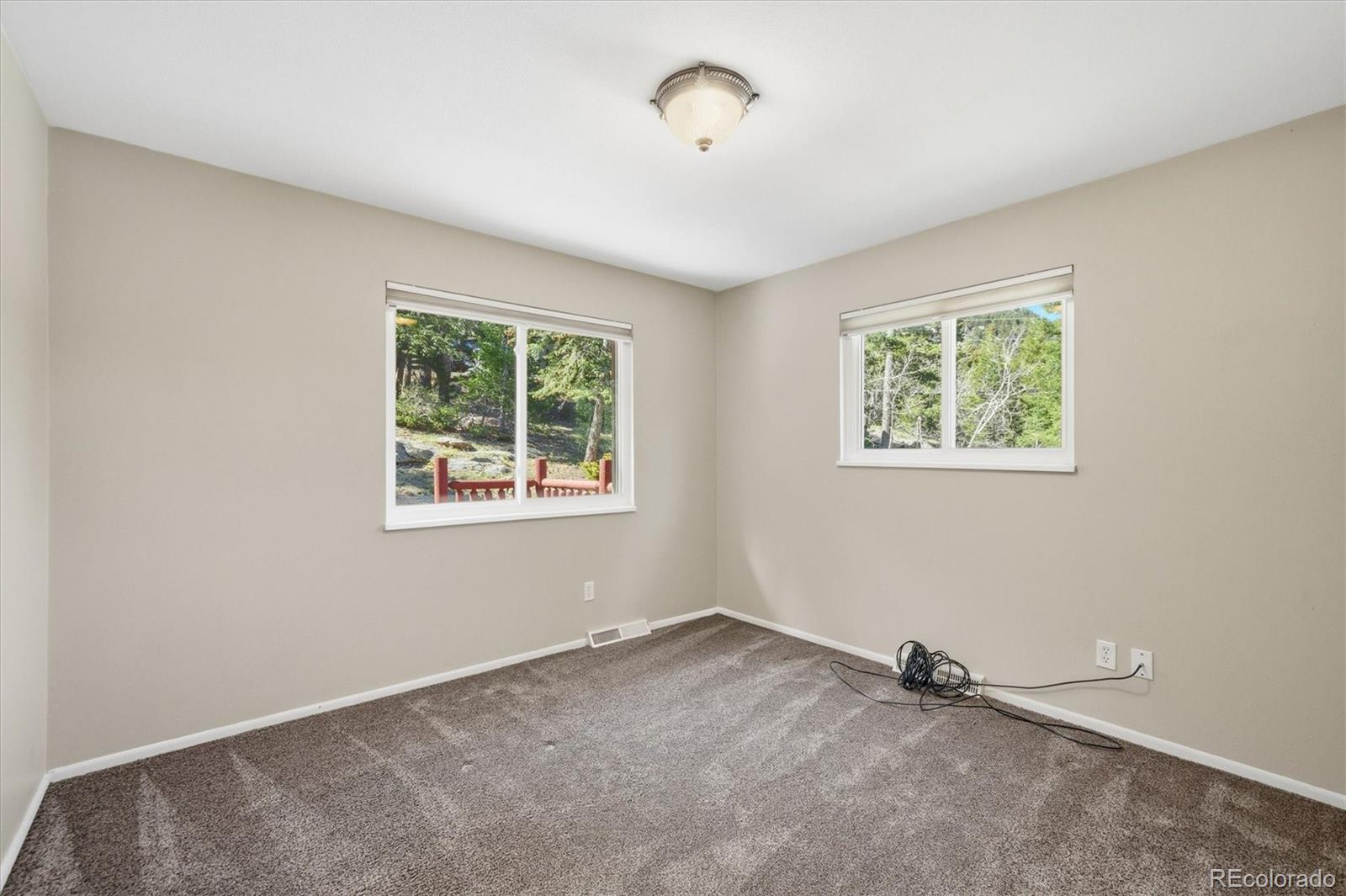 8969 South Hillview Road Morrison, CO 80465 - Photo 26 of 50 an empty room with windows