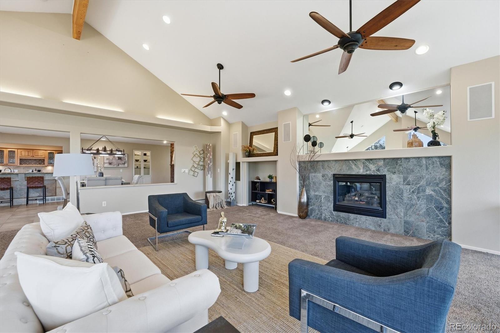 8969 South Hillview Road Morrison, CO 80465 - Photo 8 of 50 a living room with furniture and a fireplace