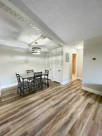 a view of a room with furniture and wooden floor