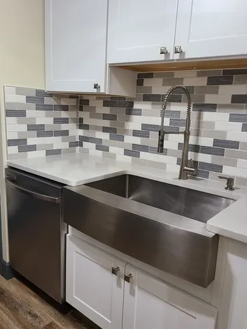a kitchen with a sink and cabinets