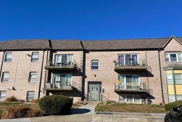a front view of a house with sitting area