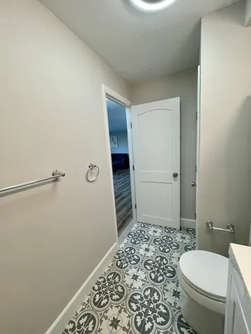 a bathroom with a toilet and a shower