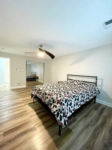 a bed sitting in a bedroom next to a window