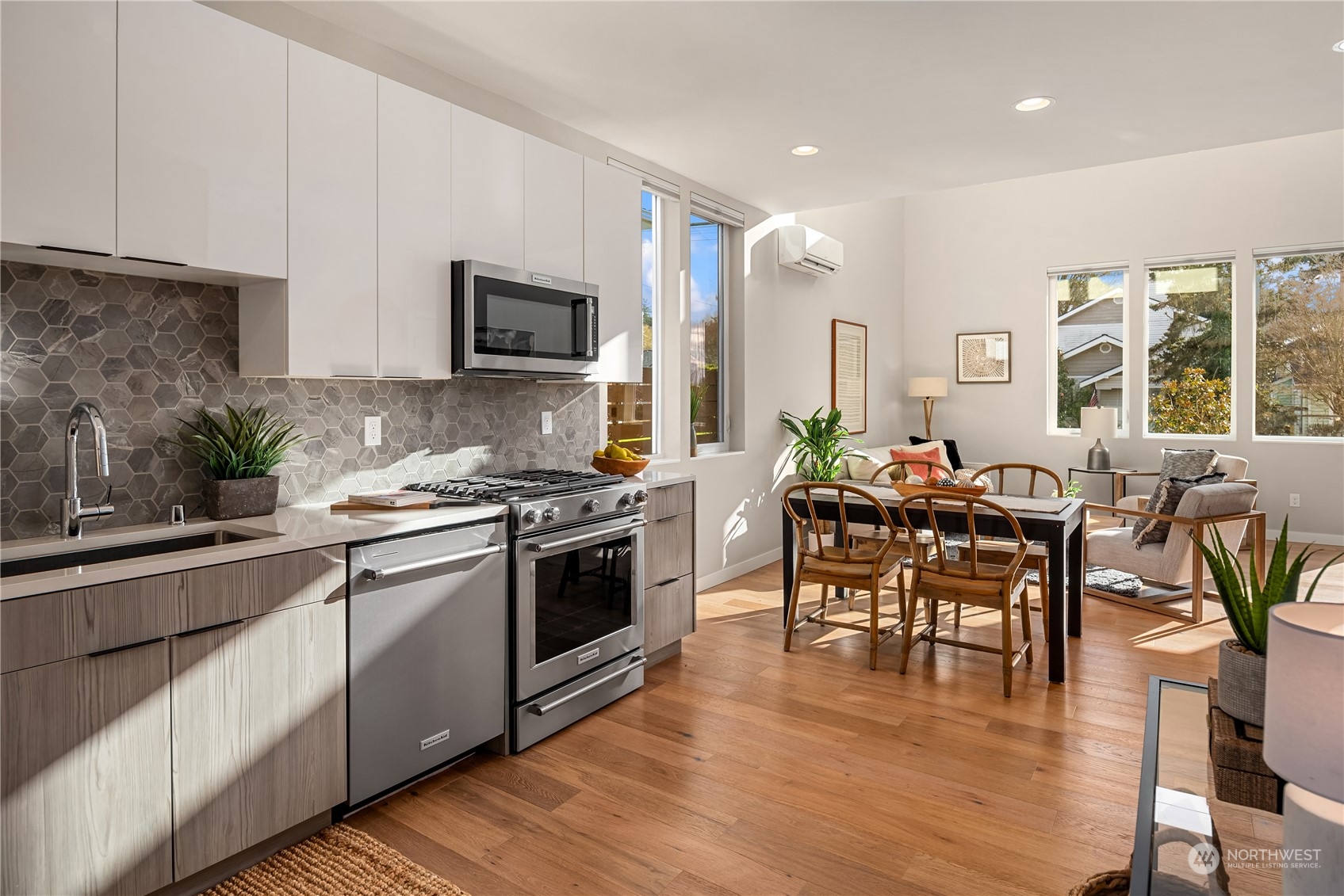 4406 Southwest Holly Street Seattle, WA 98136 - Photo 12 of 32 a kitchen with stainless steel appliances stove microwave dining table and chairs