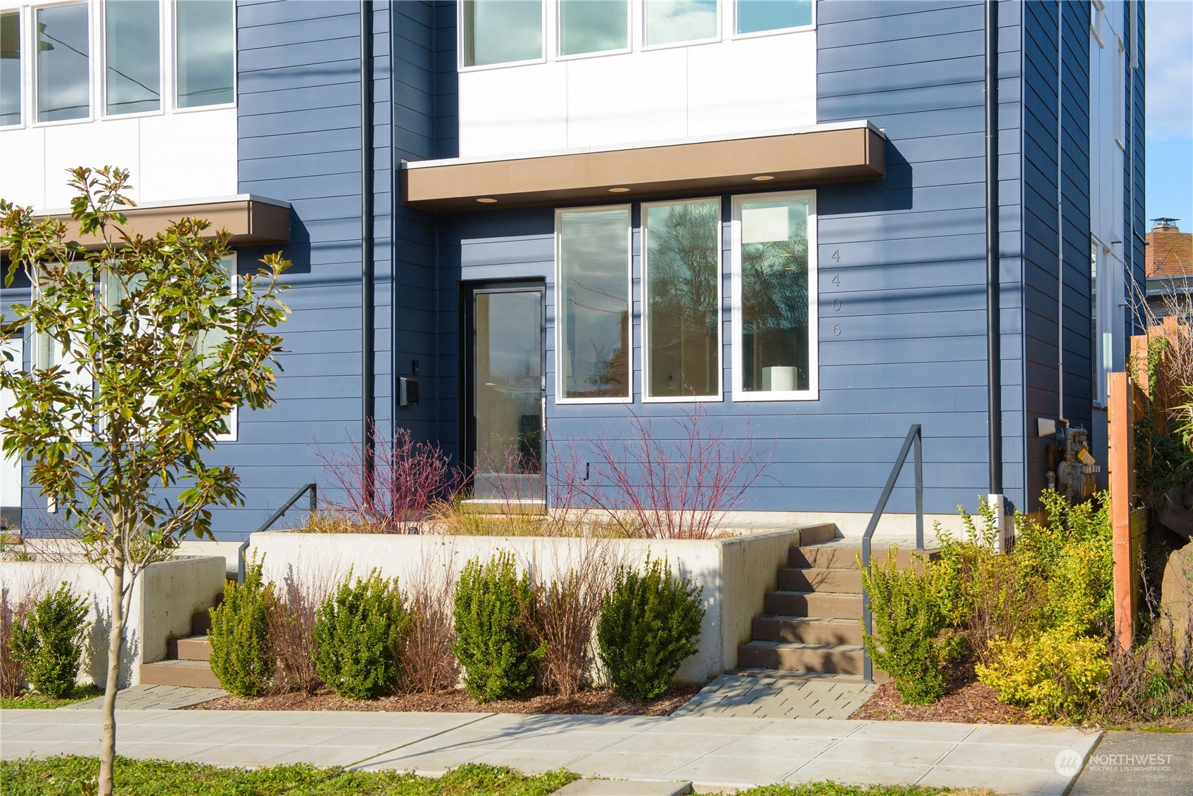 4406 Southwest Holly Street Seattle, WA 98136 - Photo 31 of 32 a view of a brick house with plants