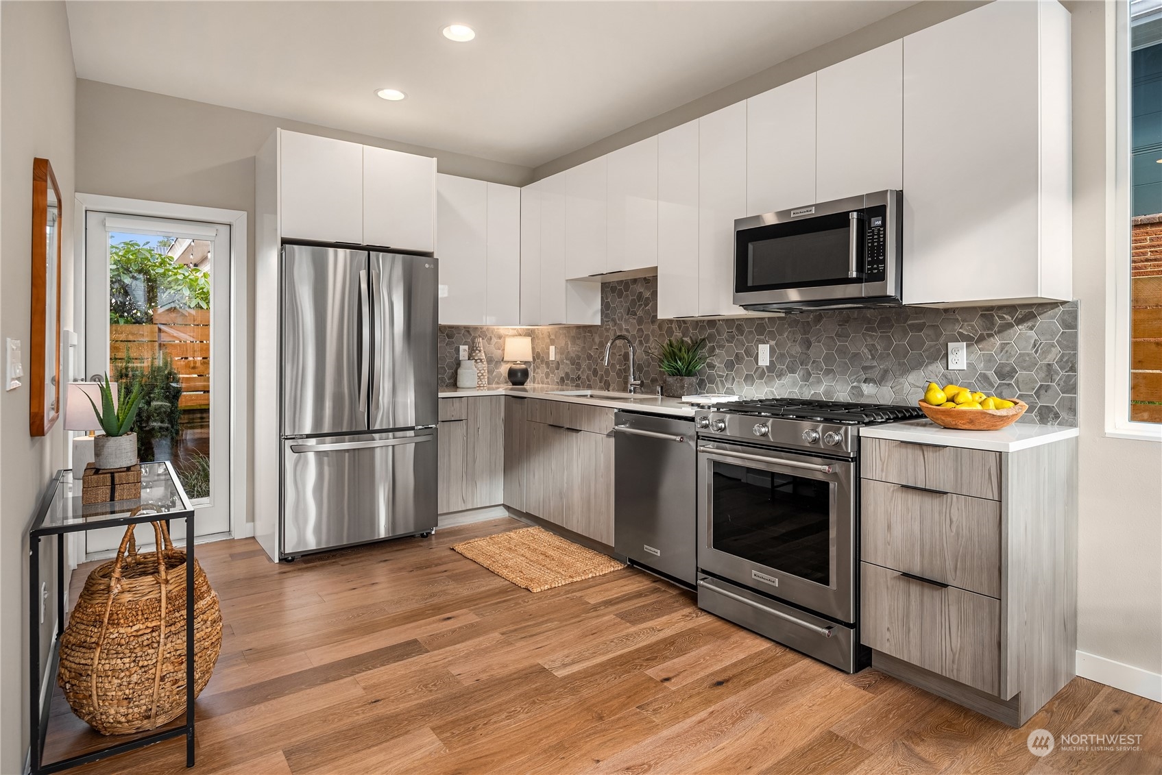 4406 Southwest Holly Street Seattle, WA 98136 - Photo 10 of 32 a kitchen with stainless steel appliances a stove a sink and a microwave