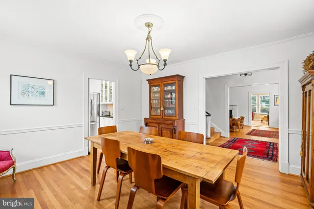 a living room with furniture a bookshelf and a flat screen tv