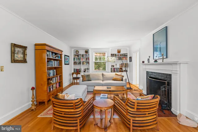 a kitchen with stainless steel appliances granite countertop a stove a sink a refrigerator and a granite counter tops with wooden floors