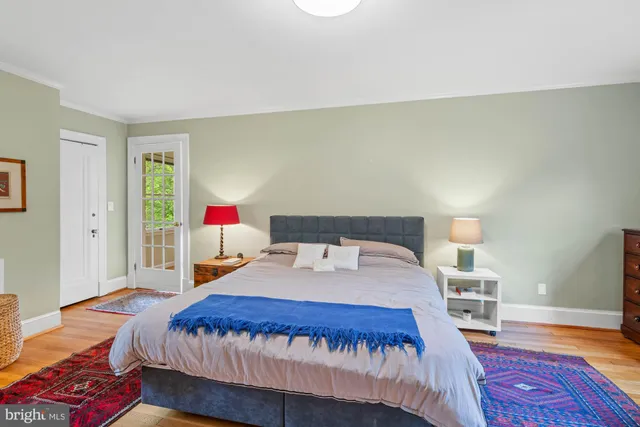 a view of a patio with table and chairs and potted plants with wooden floor and fence