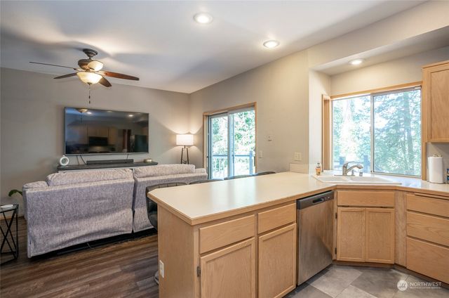 a kitchen with a stove a refrigerator and a sink