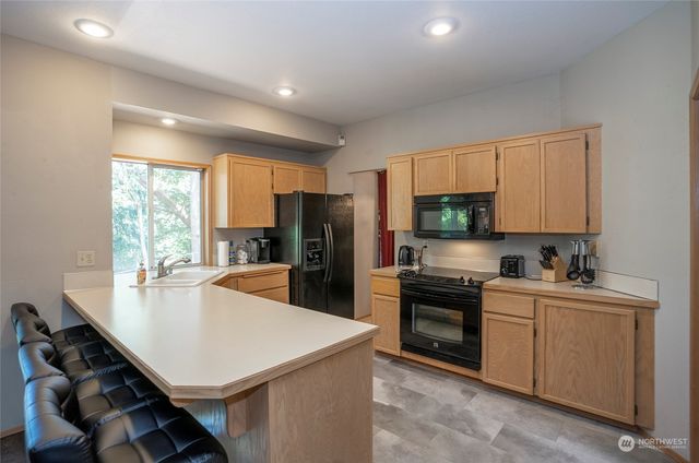 a kitchen with stainless steel appliances granite countertop a stove and a microwave
