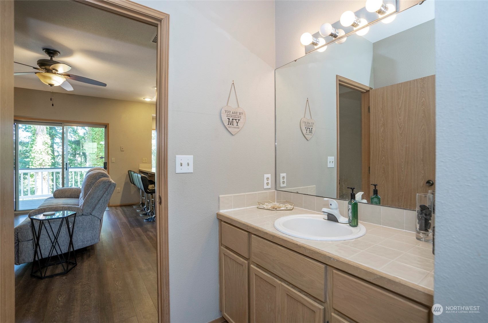 2833 Marietta Street Steilacoom, WA 98388 - Photo 16 of 40 a en suite bathroom with a granite countertop sink a light fixture and a mirror