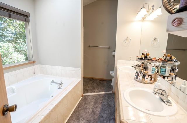 a bath tub sitting in a bathroom next to a window