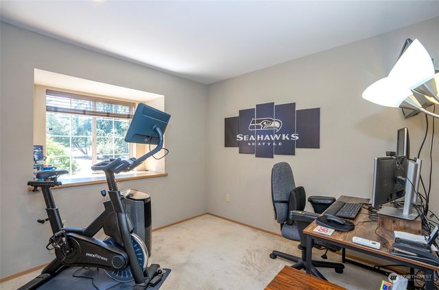 a view of a workspace with furniture and a gate
