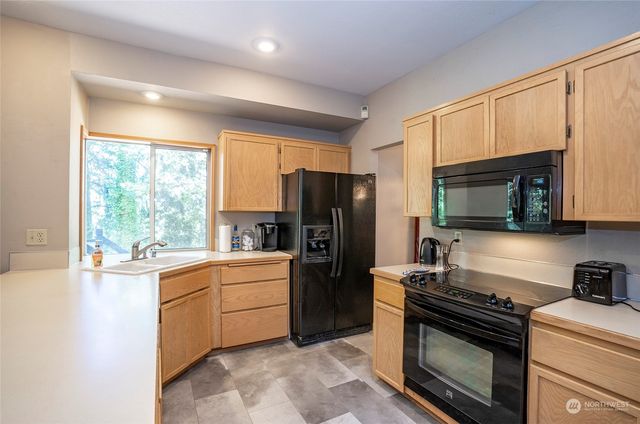 a kitchen with a stove a sink and a microwave