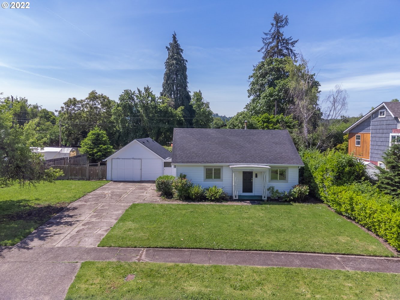 1147 F Street Springfield, OR 97477 - Photo 1 of 32 a front view of a house with a garden and yard