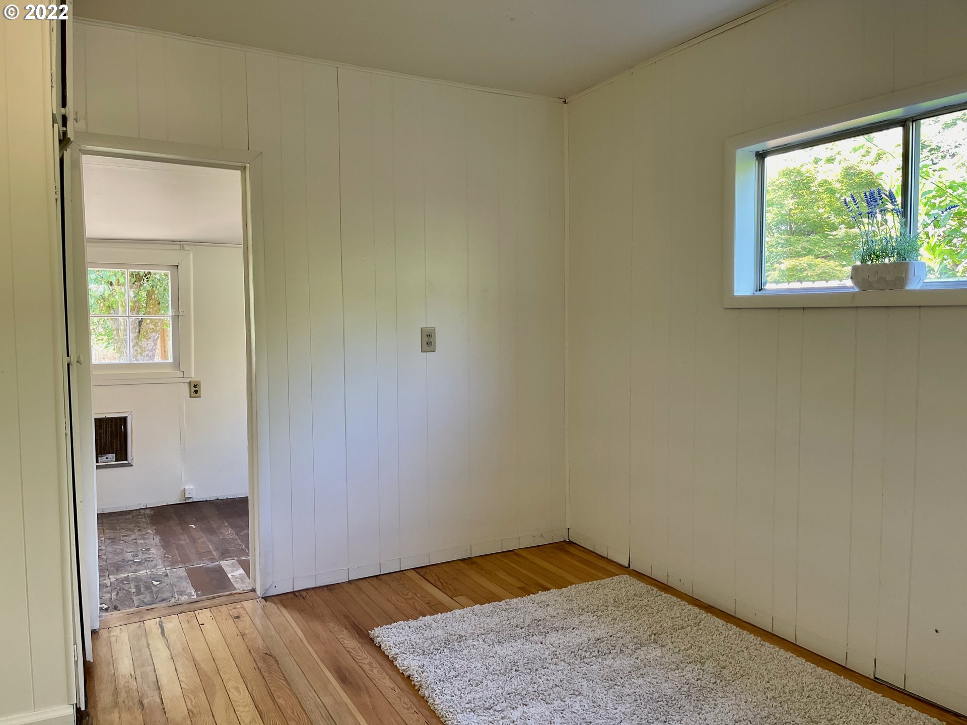 1147 F Street Springfield, OR 97477 - Photo 20 of 32 an empty room with wooden floor and windows