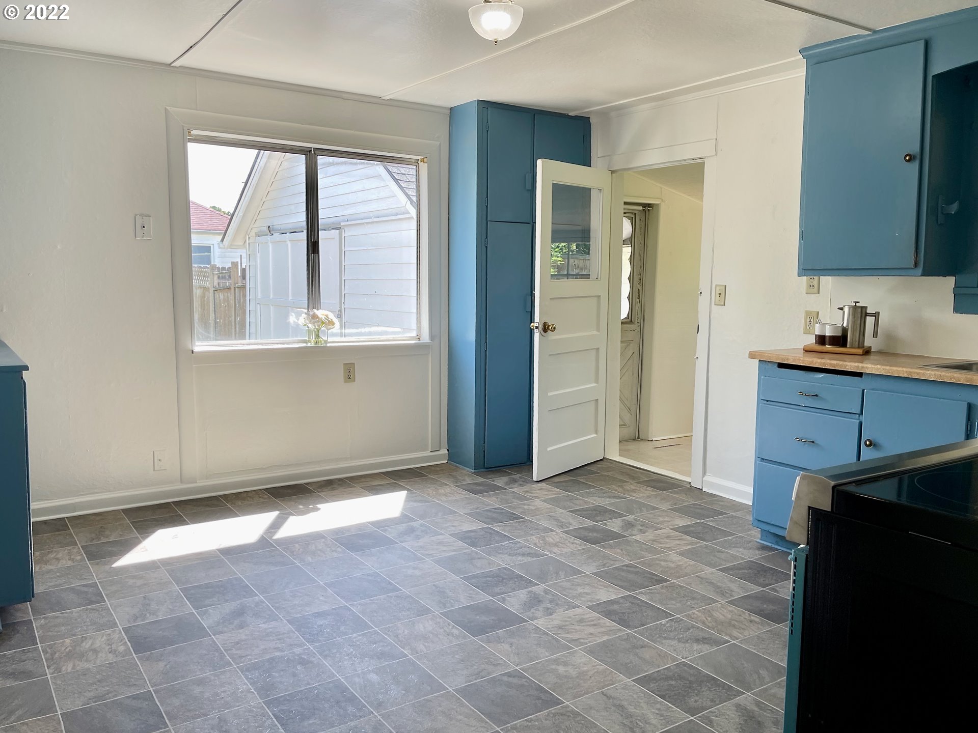 1147 F Street Springfield, OR 97477 - Photo 7 of 32 a view of a kitchen with wooden floor and a sink