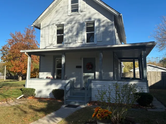 a front view of a house with outdoor seating