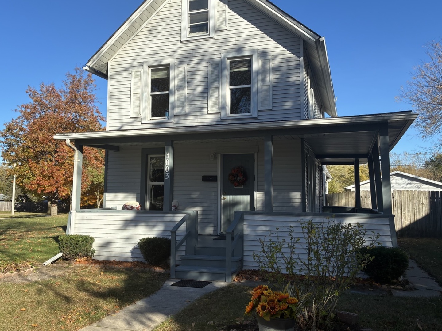 a front view of a house with outdoor seating