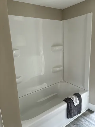 a white toilet sitting next to a window