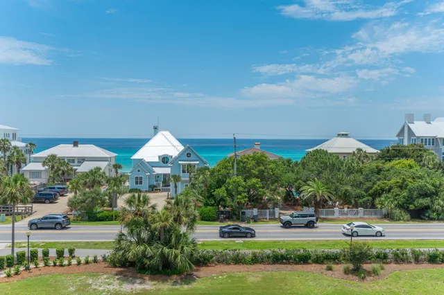 a front view of a house with a yard and lake view