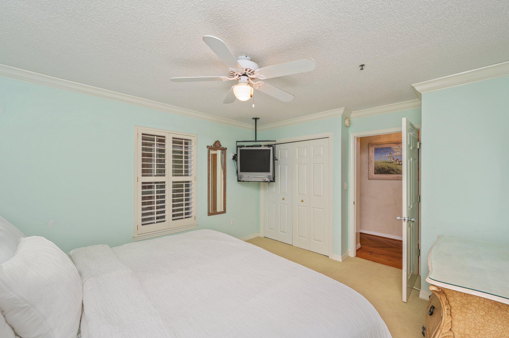 144 Spires Lane, Unit 403 Santa Rosa Beach, FL 32459 - Photo 22 of 38 a bedroom with a bed and a flat tv screen on the dresser
