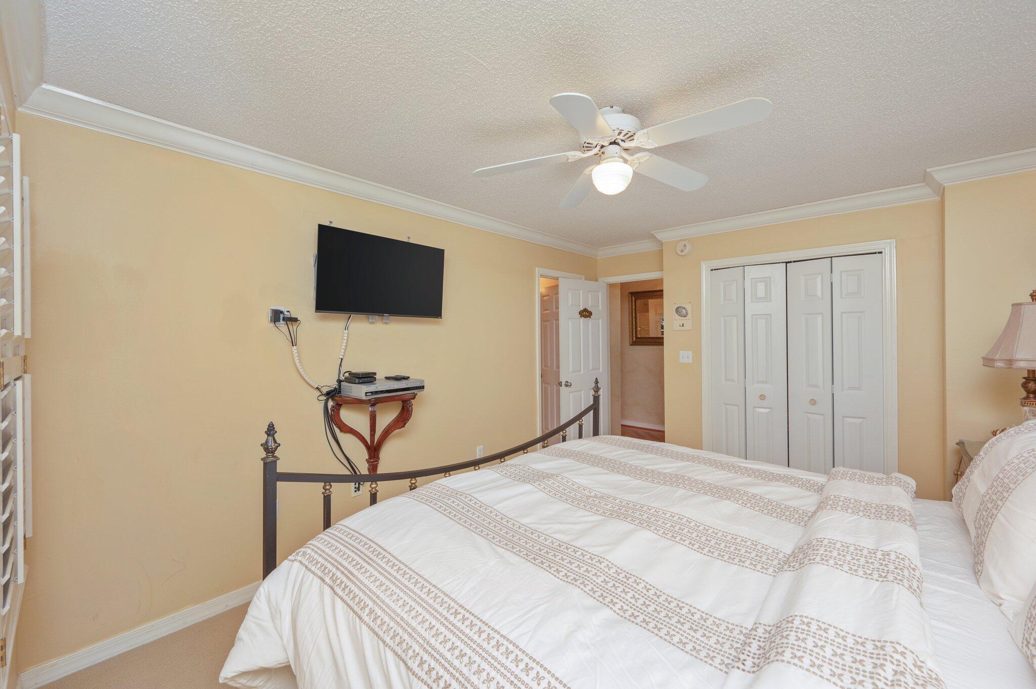 144 Spires Lane, Unit 403 Santa Rosa Beach, FL 32459 - Photo 27 of 38 a bedroom with a bed and a chandelier