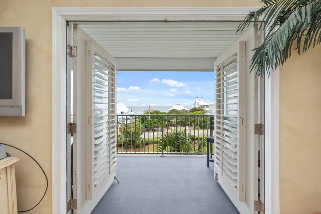 a view of a porch with furniture and floor to ceiling window
