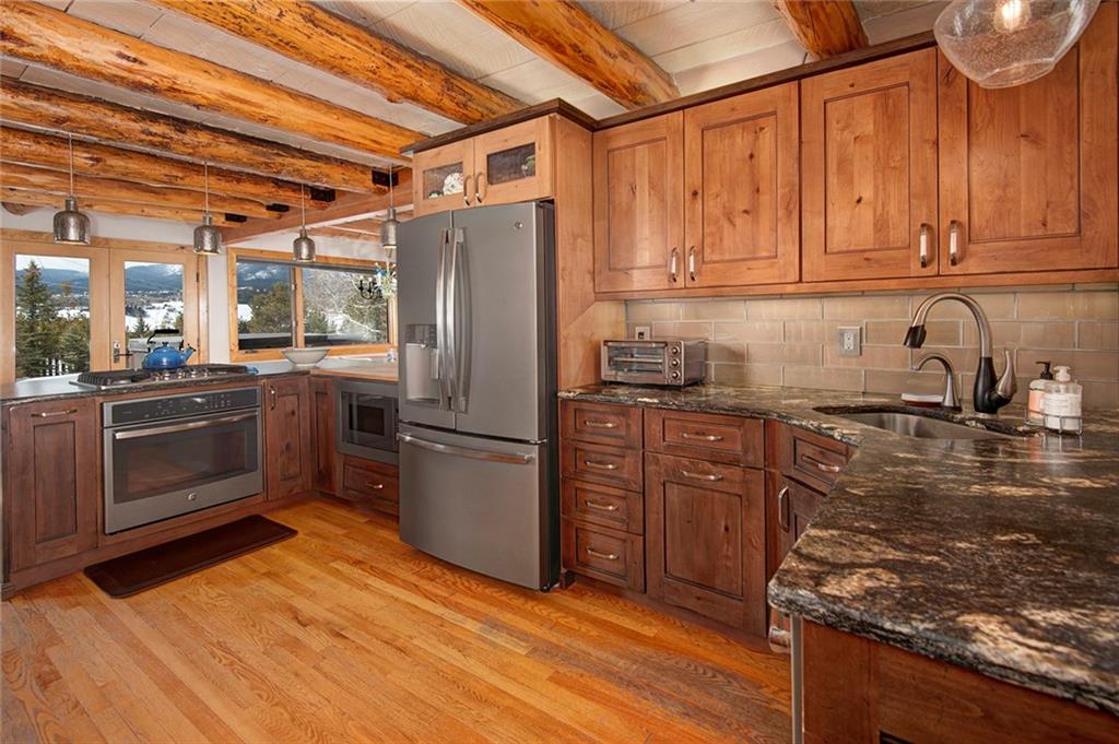 39 D Road Silverthorne, CO 80498 - Photo 13 of 35 a kitchen with granite countertop a refrigerator stove and sink
