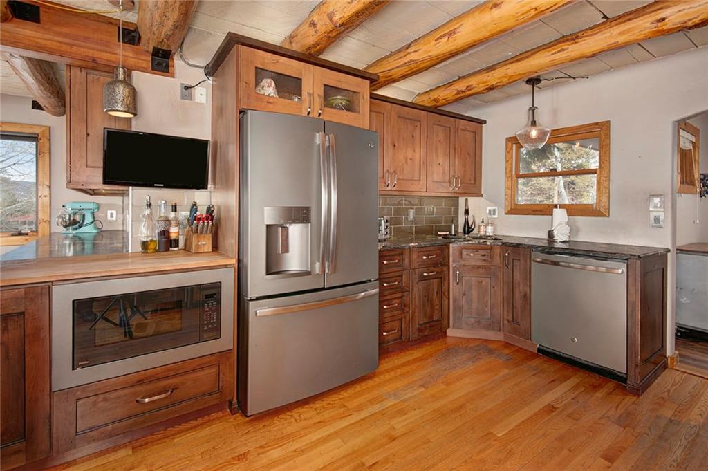 39 D Road Silverthorne, CO 80498 - Photo 14 of 35 a kitchen with stainless steel appliances a stove refrigerator sink and wooden floor