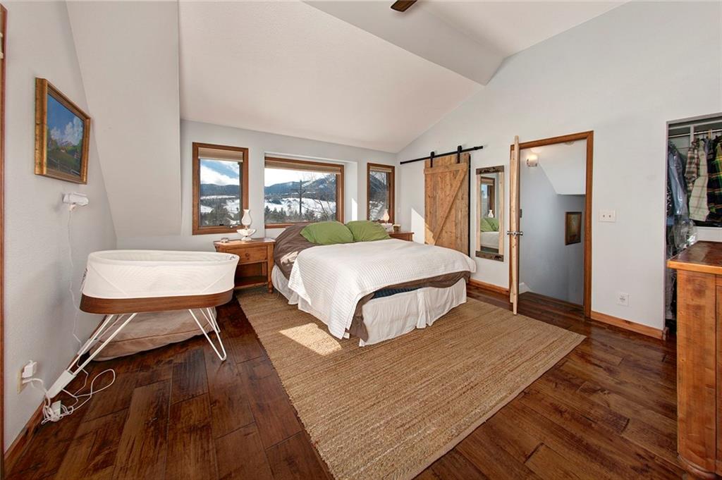 39 D Road Silverthorne, CO 80498 - Photo 20 of 35 a bedroom with a bed a dresser and a large mirror next to a window