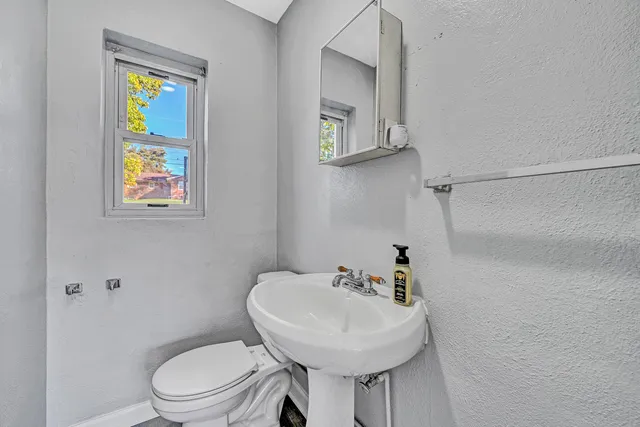 a white toilet sitting next to a bathroom sink