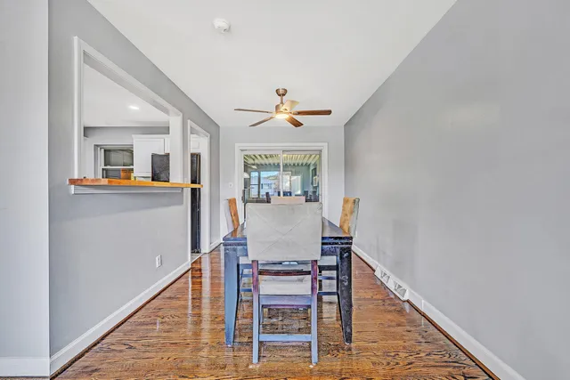 a dining room with furniture window and wooden floor