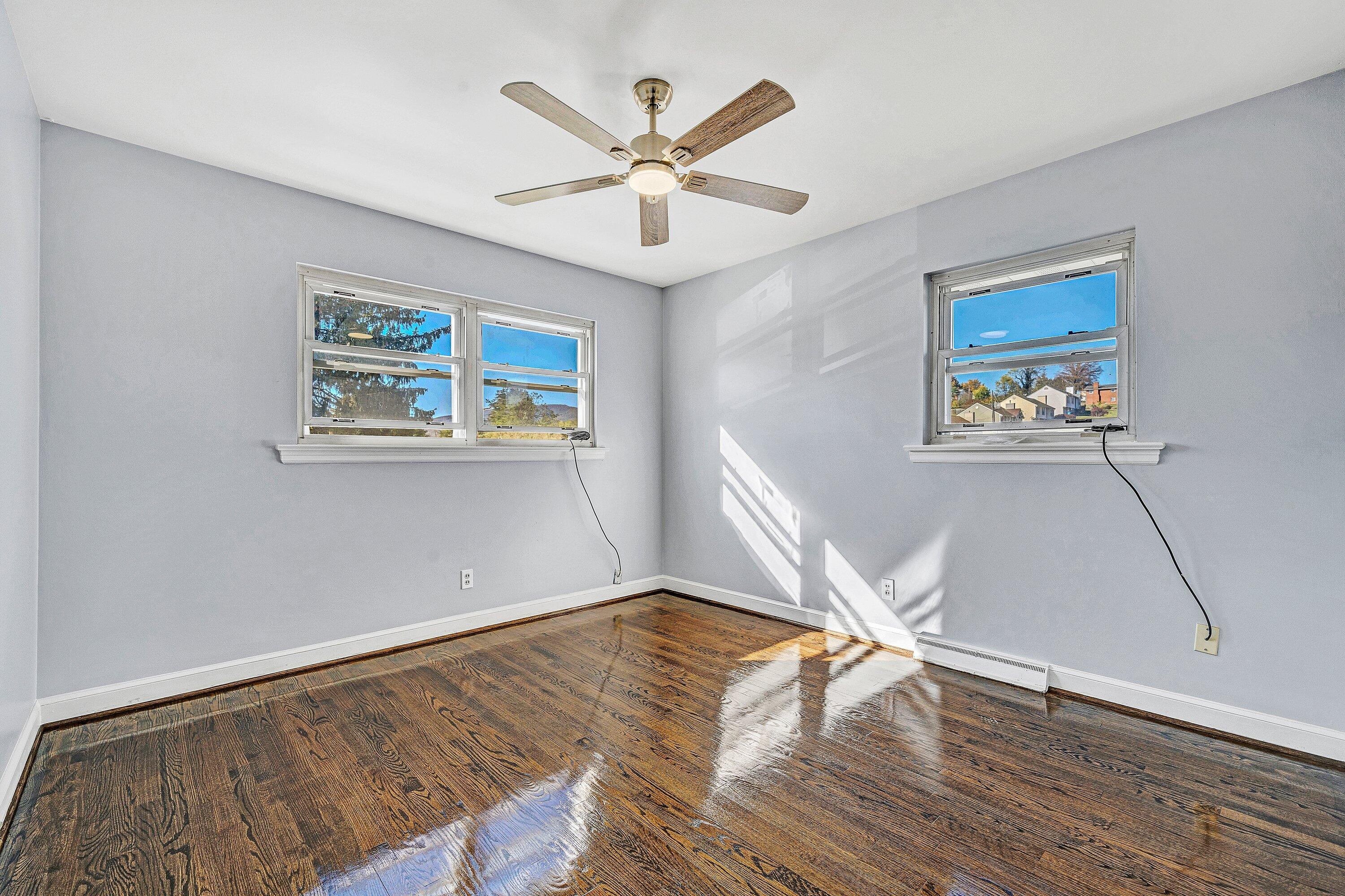 1633 Angus Road Northwest Roanoke, VA 24017 - Photo 10 of 22 a view of an empty room with wooden floor and a ceiling fan