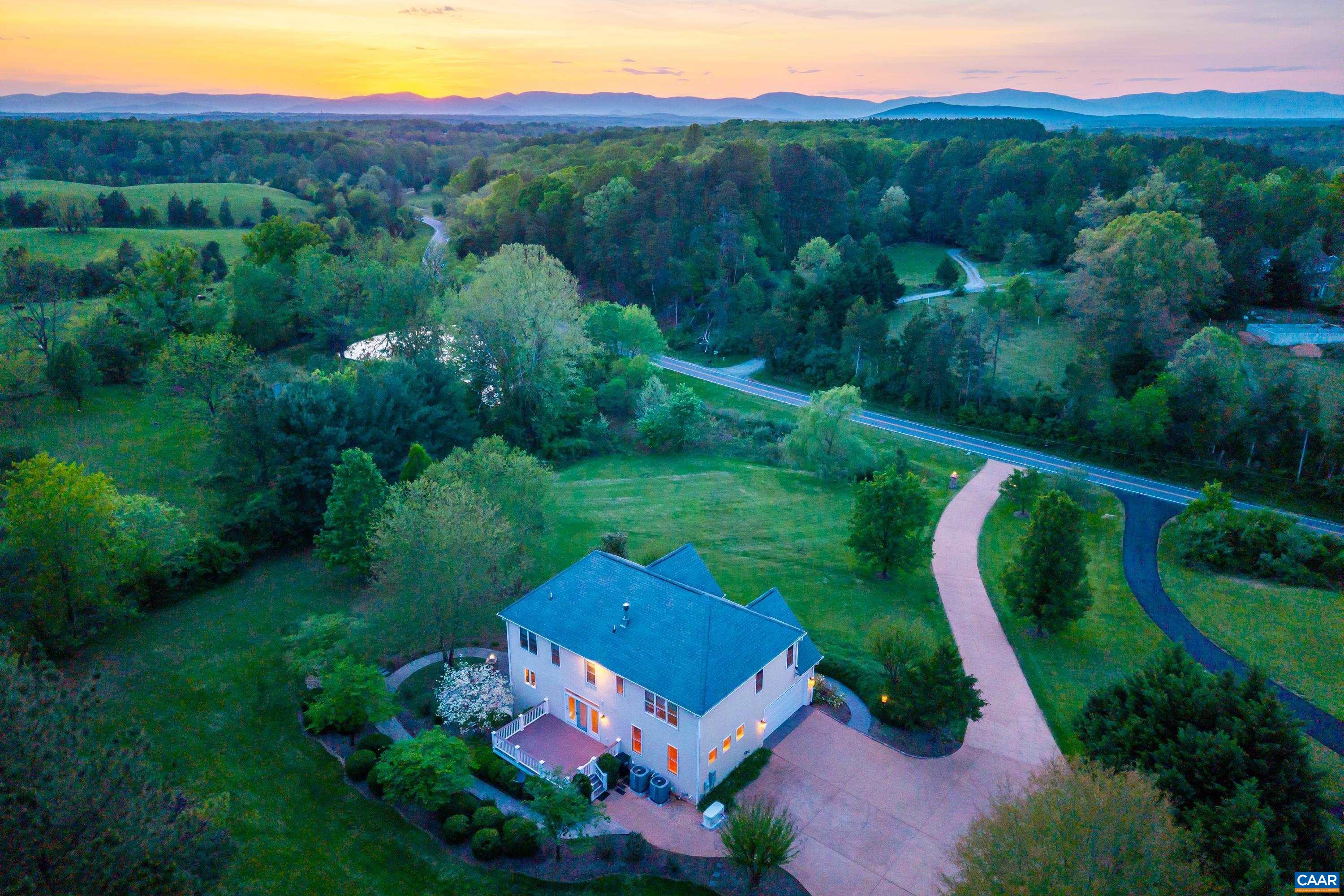 an aerial view of a house with pool