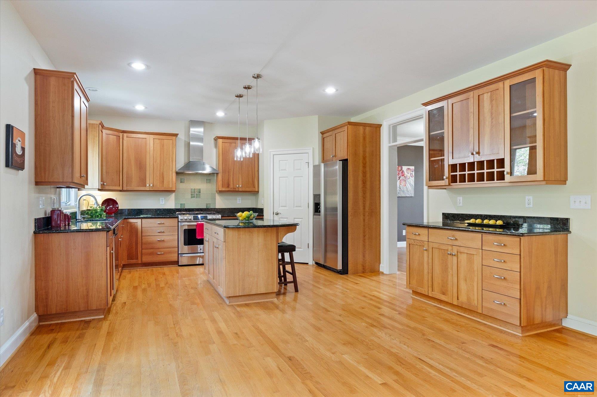 4269 Stony Point Road Keswick, VA 22947 - Photo 12 of 25 a kitchen with stainless steel appliances granite countertop a refrigerator a stove top oven and a wooden floors