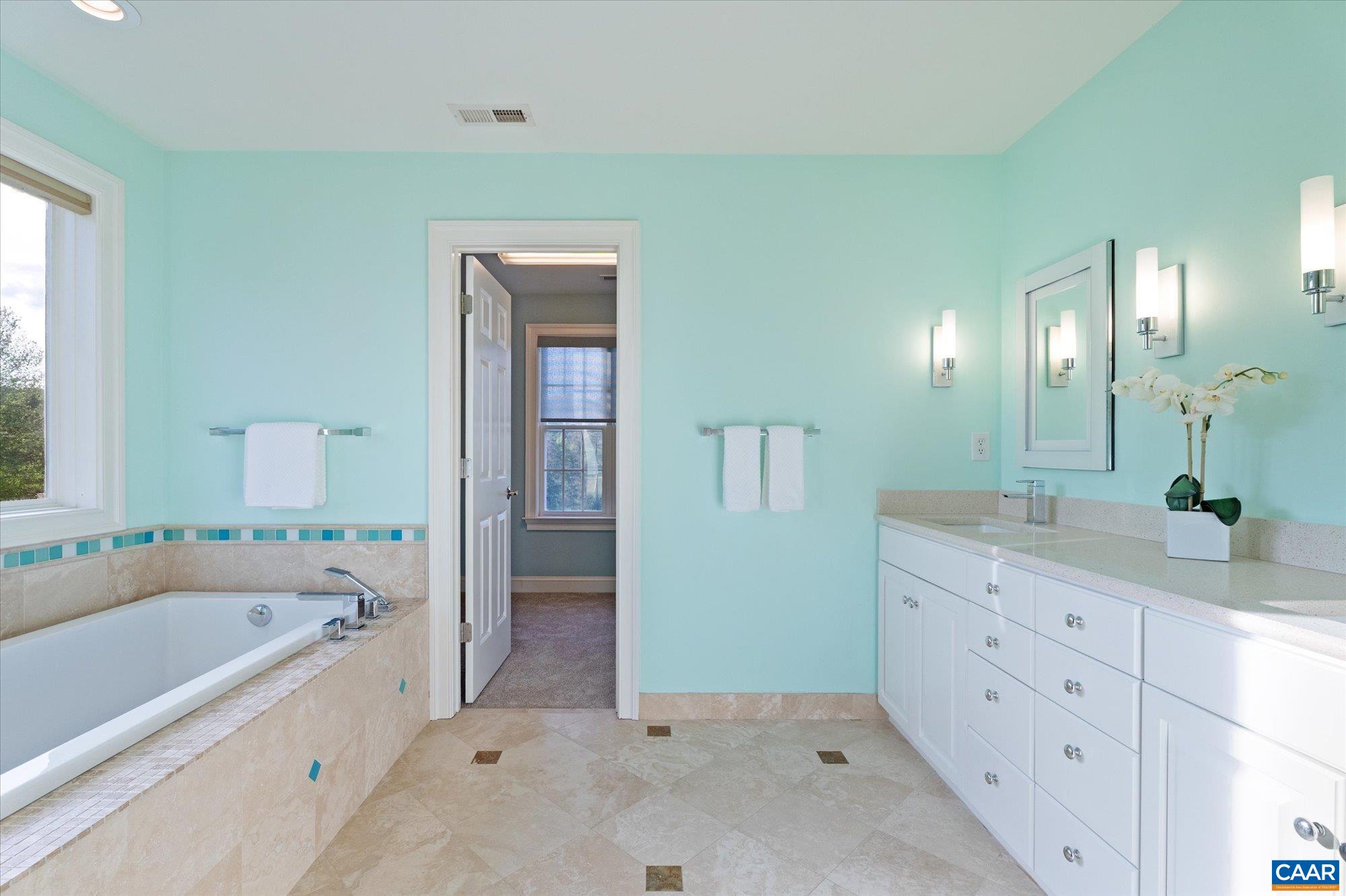 4269 Stony Point Road Keswick, VA 22947 - Photo 15 of 25 a spacious bathroom with a tub sink and mirror