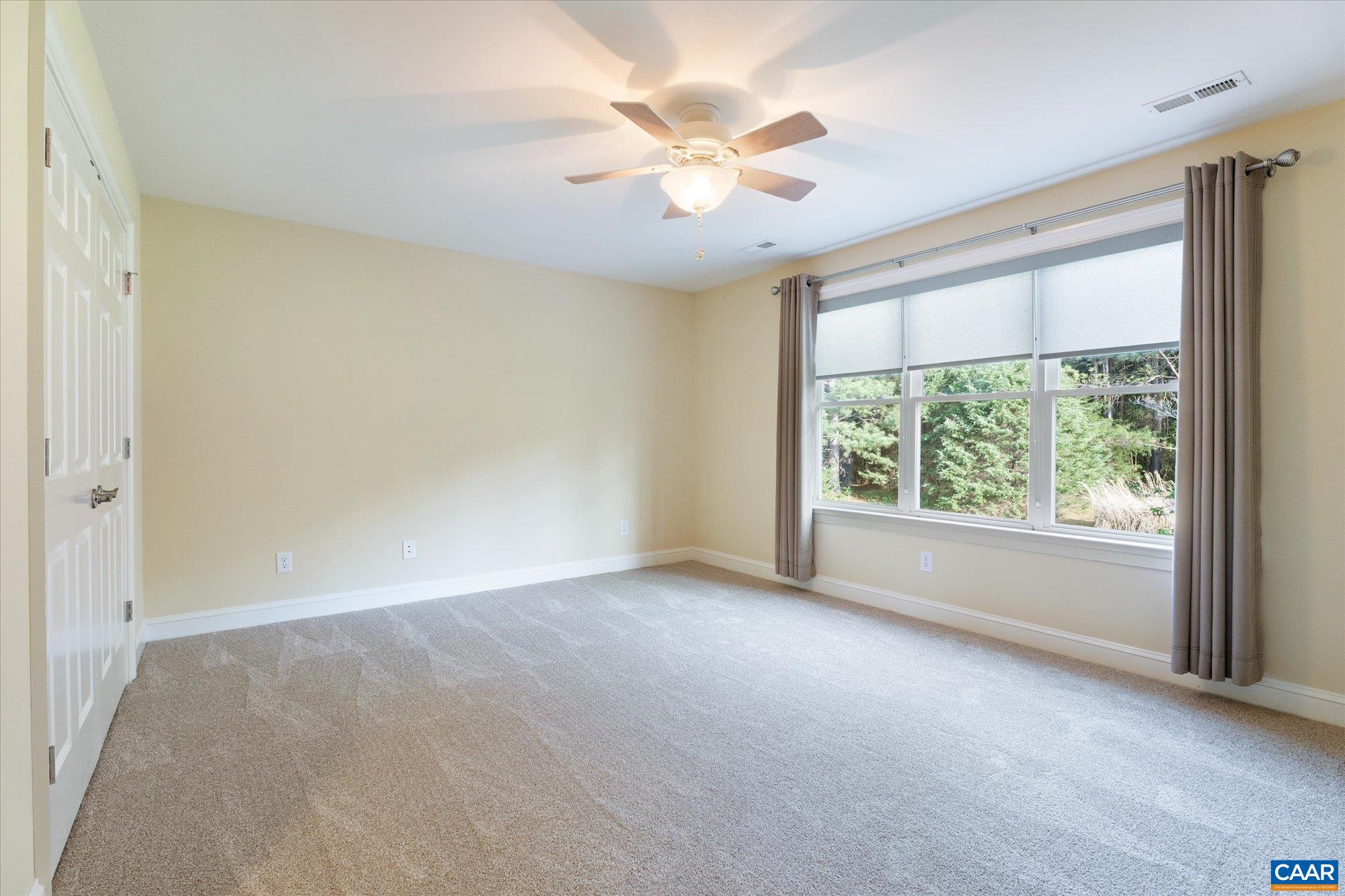 4269 Stony Point Road Keswick, VA 22947 - Photo 19 of 25 an empty room with windows and chandelier fan