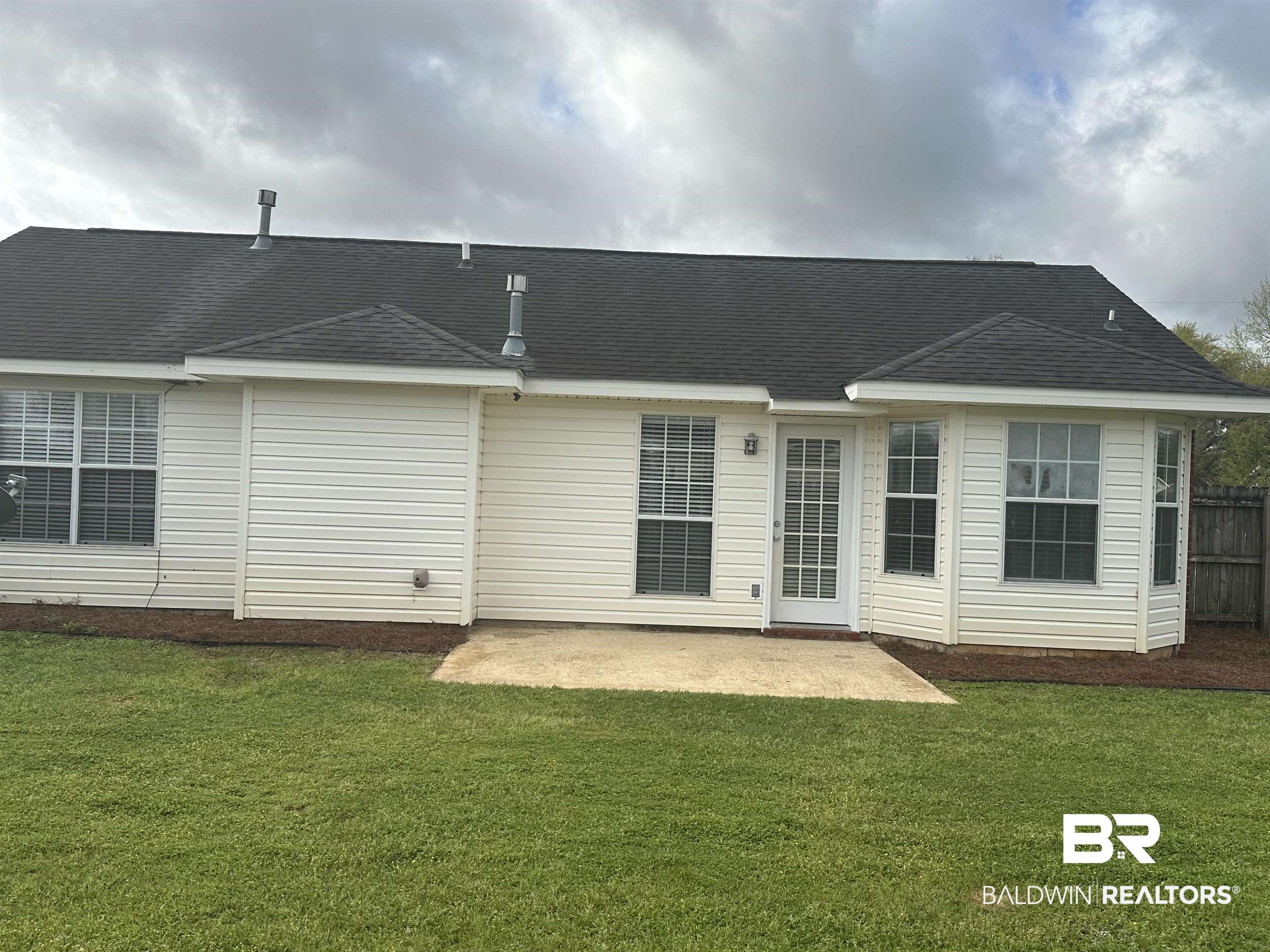 4882 Rebecca Place Mobile, AL 36695 - Photo 10 of 29 Back of house featuring a yard, a patio, roof with shingles, and fence