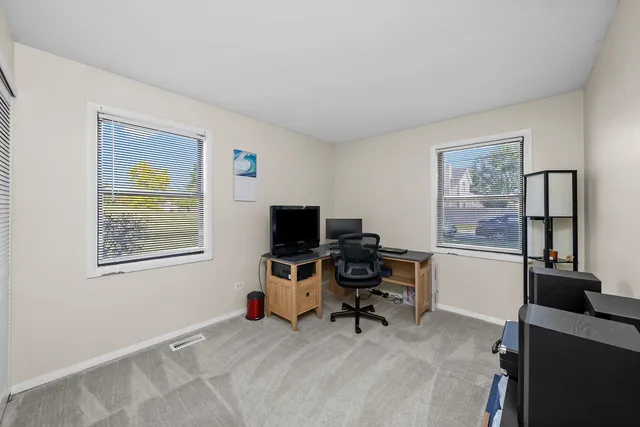 a view of a workspace with a window and chair