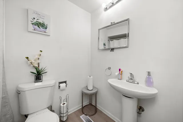 a bathroom with a toilet sink and mirror