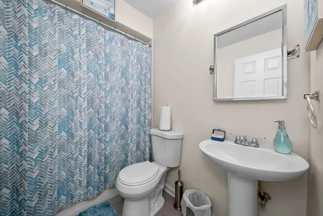 a bathroom with a sink a toilet and mirror