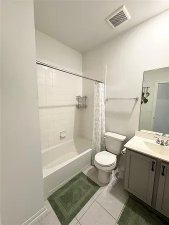 an empty room with wooden floor and hallway