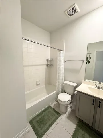 an empty room with wooden floor and hallway