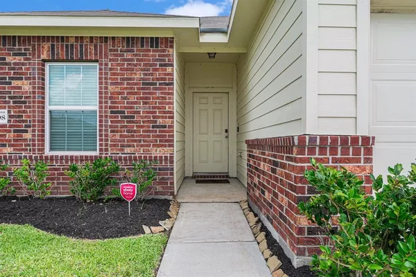 a view of a kitchen with a sink and a refrigerator