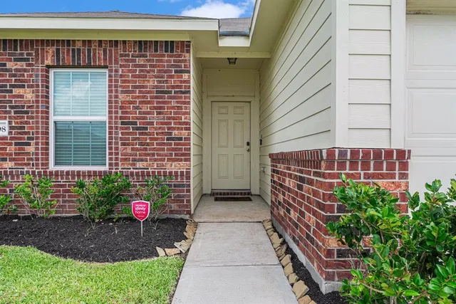a view of a kitchen with a sink and a refrigerator